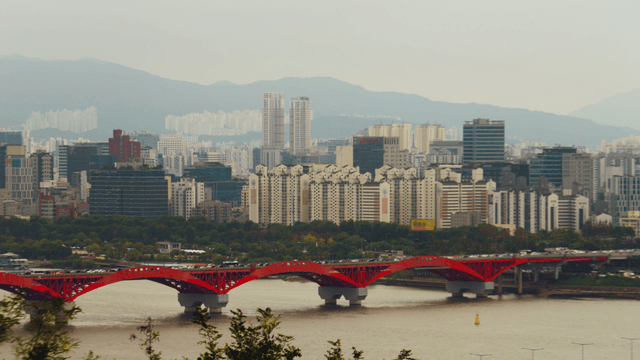 Seoul cityscape with a red bridge over the Han River