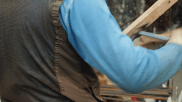 Worker using a hammer on a construction site