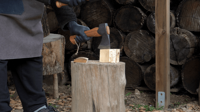 Chopping wood with an axe outdoors