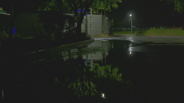 Quiet night street with a large puddle