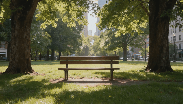 Peaceful park bench under tree in urban background