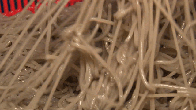 Freshly made noodles being prepared