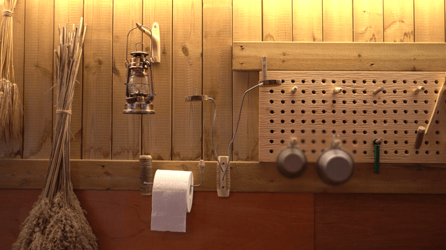 Rustic workshop with lantern, tools, and wooden walls