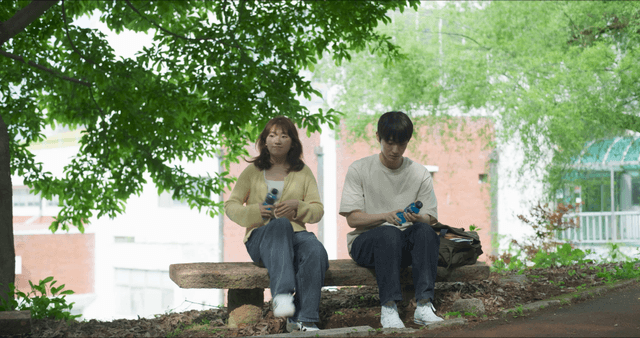 Two people having a conversation on a bench