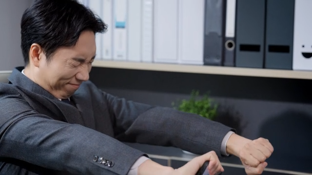 A man waking up after finishing work at the office