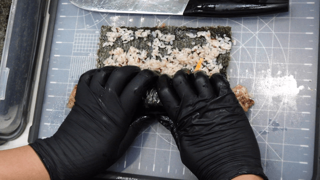 Chef rolling pork belly gimbap