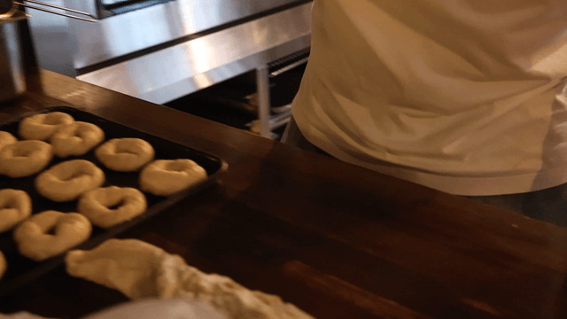 Baker preparing bagel dough in the kitchen
