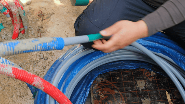 Workers handling cables at a construction site