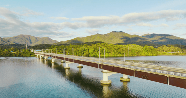 Bridge over a river with mountains