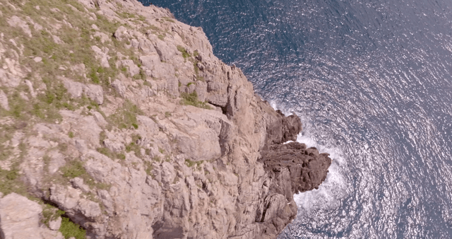 Rocky coastal cliffs with lush greenery