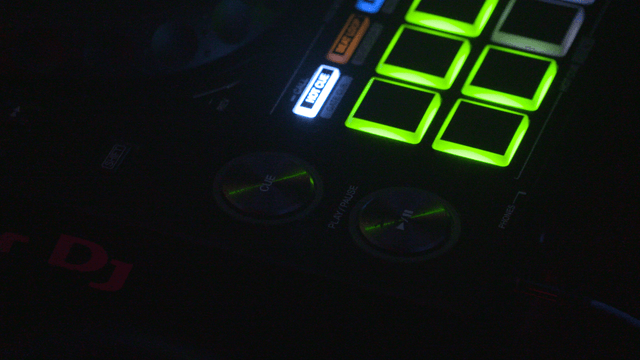 DJ equipment illuminated with colorful lights