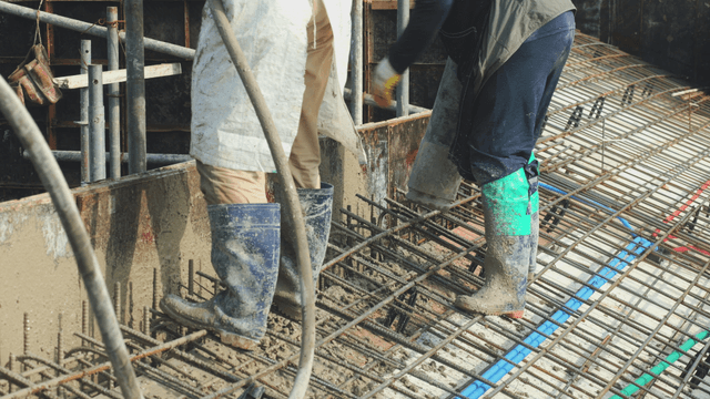 Construction workers pouring concrete
