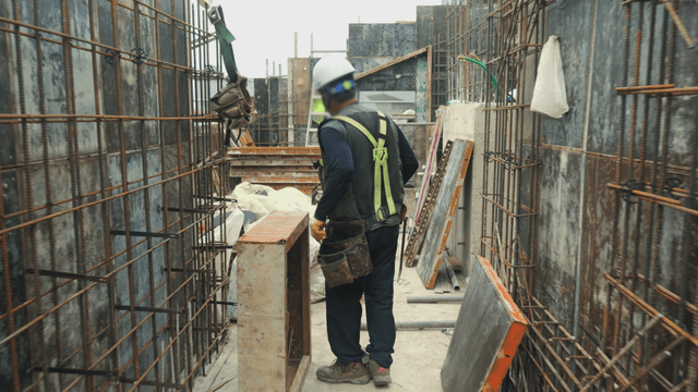 Worker using a hammer on a construction site