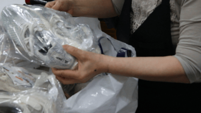 Person taking shoes out of a plastic bag