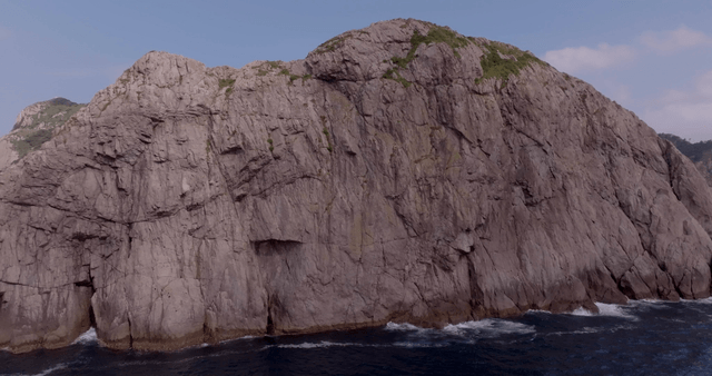 Rocky coastline with a distant boat