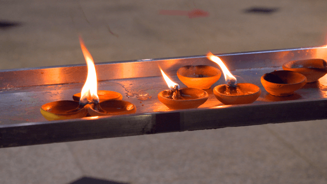 Candles burning on a metal tray