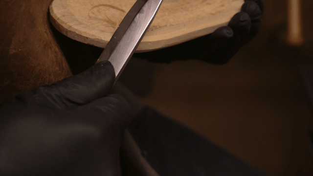 Woodcraft artisan carving wood piece with fine knife