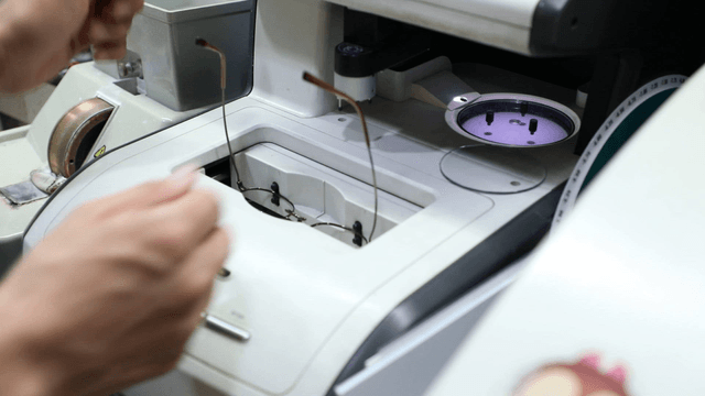 Person operating a lens grinding machine