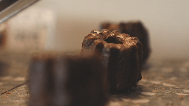 Chocolate-colored cannele on display
