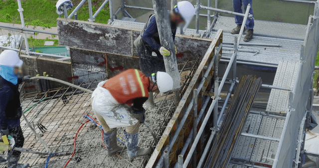 Construction workers pouring concrete