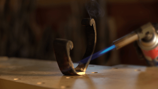 Woodcraft artisan heating the wooden surface with a torch