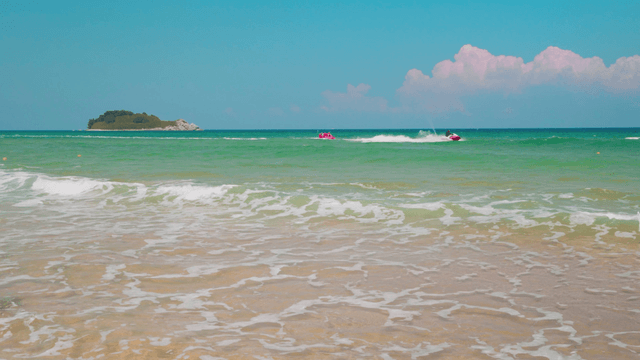 Jet ski riding across clear sea