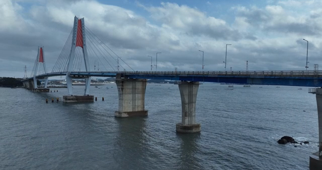A large bridge spanning over a calm sea