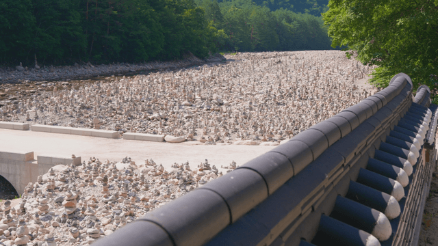 Stone towers stacked beyond traditional hanok wall