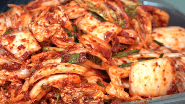 Freshly made kimchi on a stainless tray