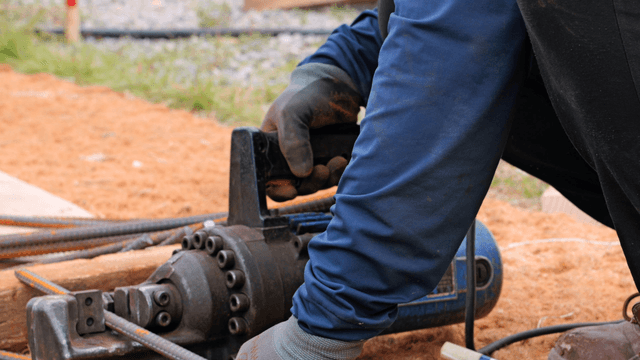 Worker using a tool at a construction site