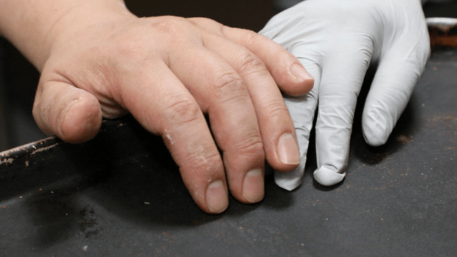 Hands gathering over a metal tray