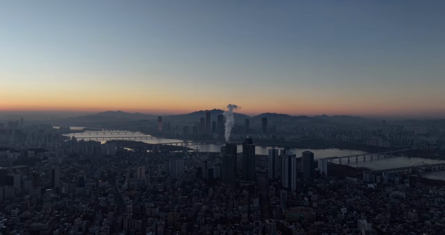 City skyline at dawn with a river view