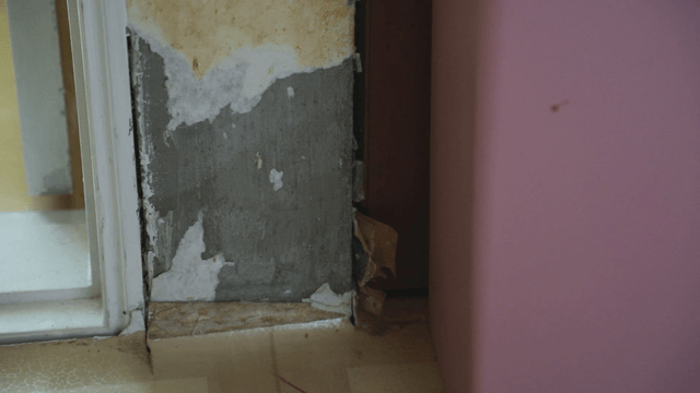 Damaged wall corner with peeling paint
