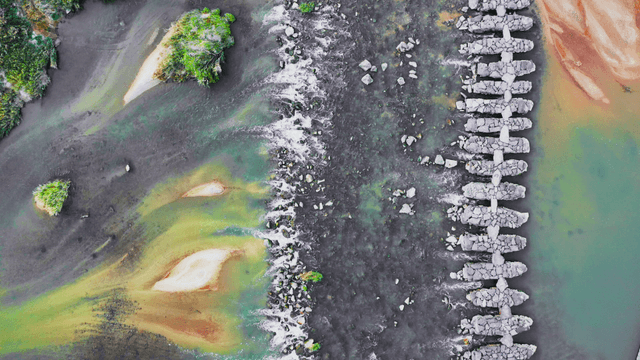 Aerial view of a stone bridge stretching over a waterway