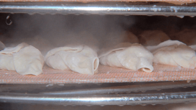 Dumplings being steamed in a steamer