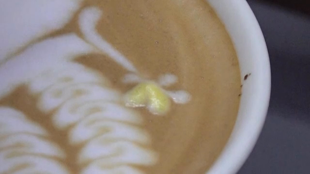 Latte art being created in a coffee cup