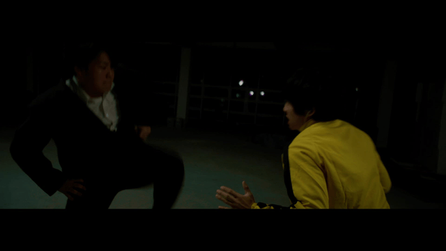 Martial arts scene in a dimly lit room