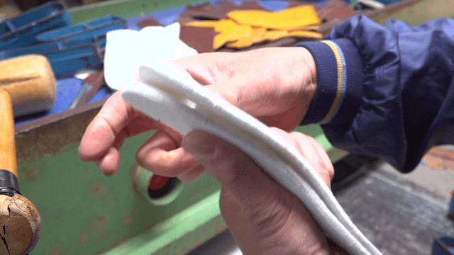 Worker handling fabric in factory workspace