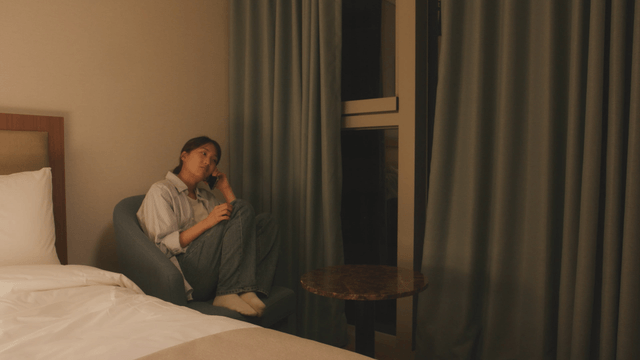 Woman talking on the phone in a cozy room