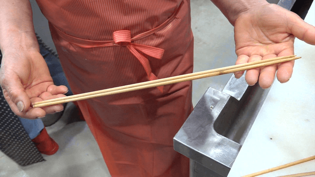 Chef inspecting wooden cooking chopsticks