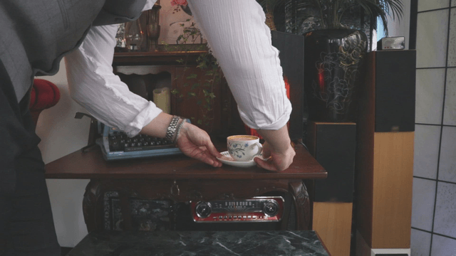 Placing a cup of coffee on a vintage table