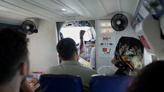 Passengers seated inside a small airplane