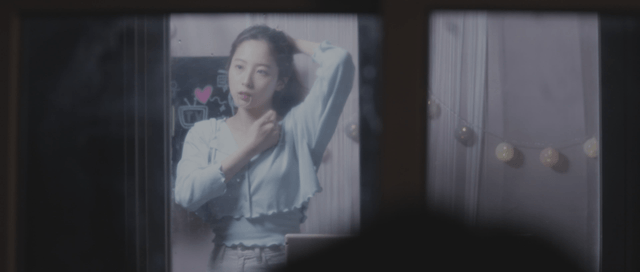 Woman adjusting her hair indoors