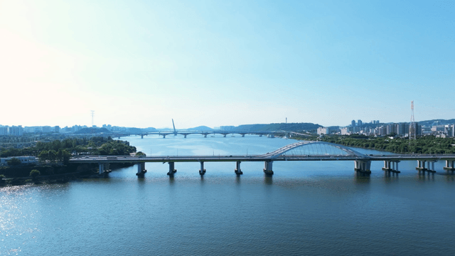 Busy bridge and city skyline over the river