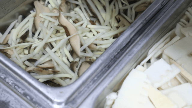 Sliced mushrooms and bamboo shoots in a tray