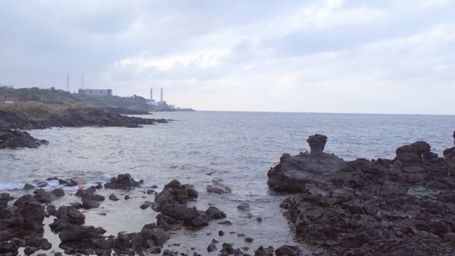 Rocky coastline with distant buildings