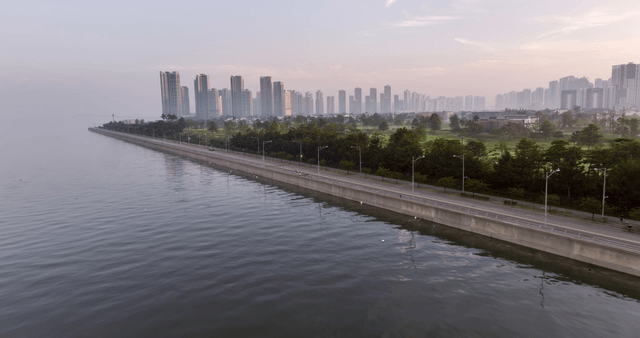 Quiet coastal road and cityscape