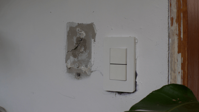 Light switch on white concrete wall