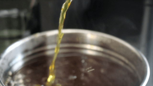 Ladle lifting herbal broth