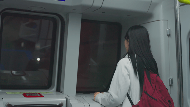 Young woman looking out subway window